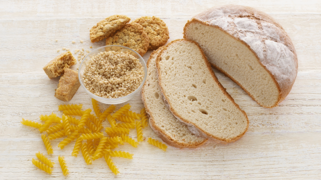 Essential Dental Care for Celiac Disease 1 - Professional Dental Common gluten-containing foods, including sliced bread, pasta, and wheat, that must be removed from the diet.