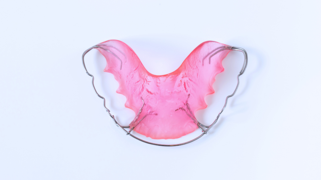 Clear orthodontic retainer on a white background at Professional Dental in Utah