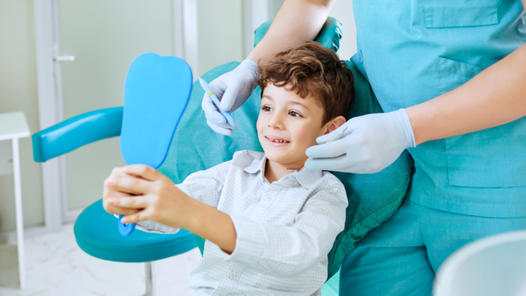 Young boy looking in a mirror during a dental evaluation for pacifier and thumb sucking impact at Professional Dental in Utah.