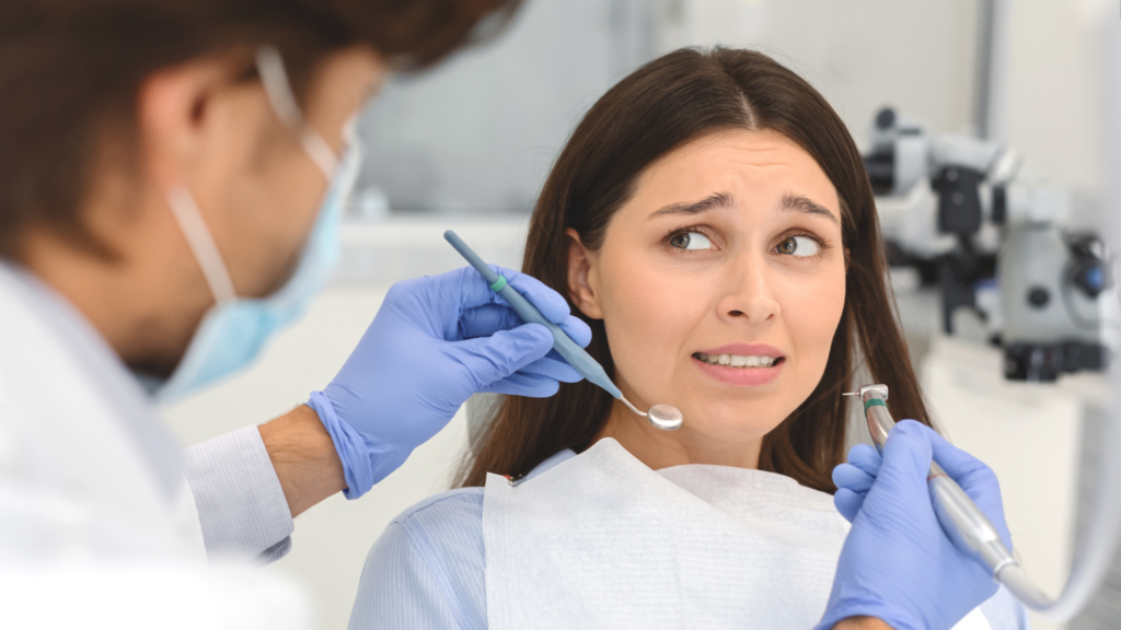 Patient speaking with a dentist about dental anxiety and ways to feel more comfortable during a dental appointment.